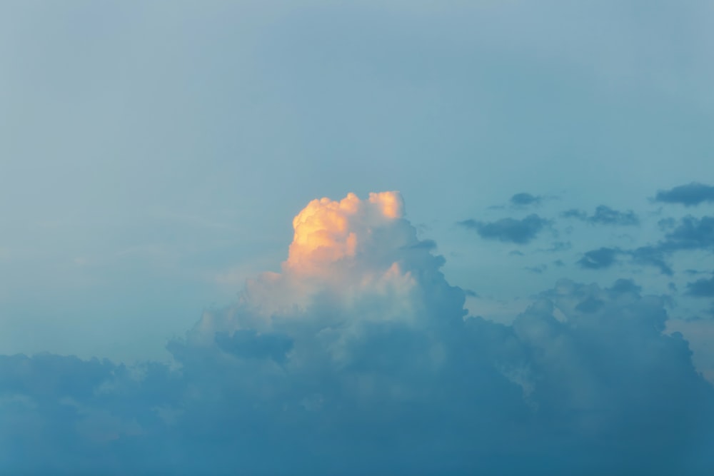 a large cloud in the sky with a yellow light