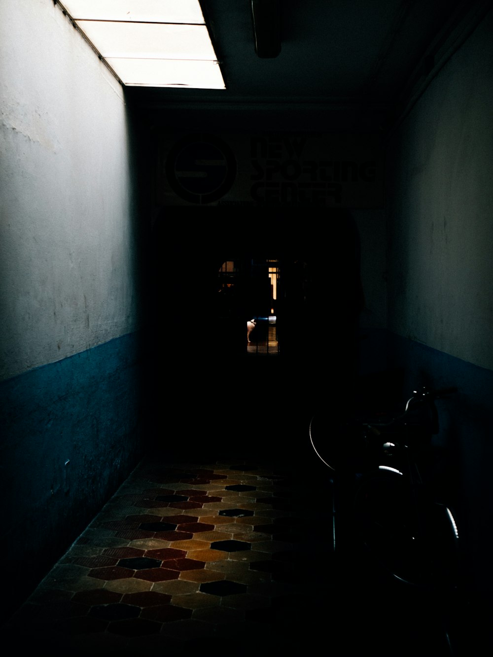 a bike is parked in a dark hallway