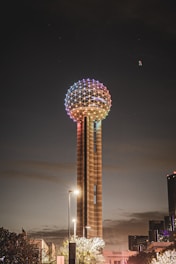 a very tall tower with a colorful light on top