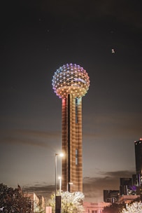 a very tall tower with a colorful light on top