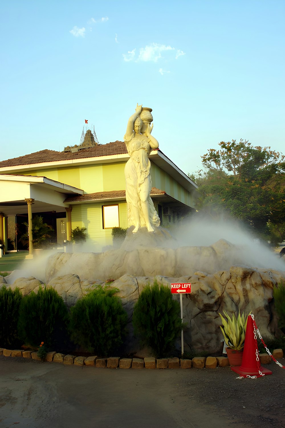 a fire hydrant spraying water on a statue
