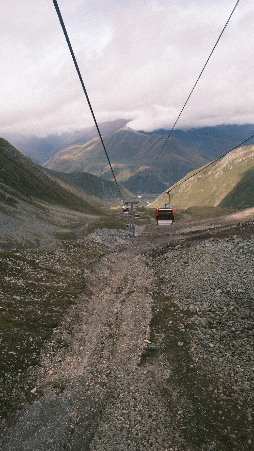 a view of a mountain with a cable car going up it
