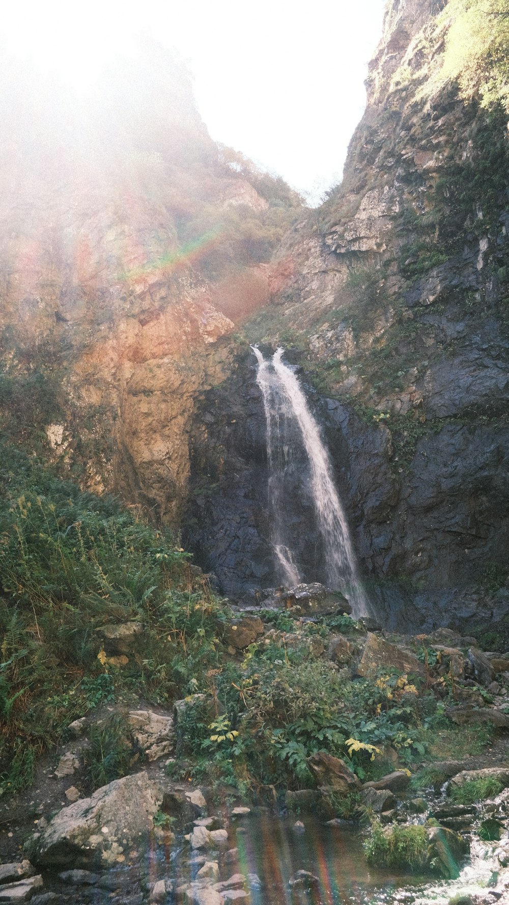 a waterfall with a rainbow in the middle of it