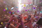 A vibrant college event with students sharing pictures and enjoying the celebration.