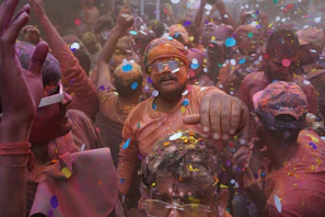 A lively festival celebration in West Bengal with dancers in bright costumes.