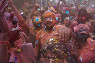 A vibrant crowd dancing and celebrating at a colorful event in Sonebhadra.