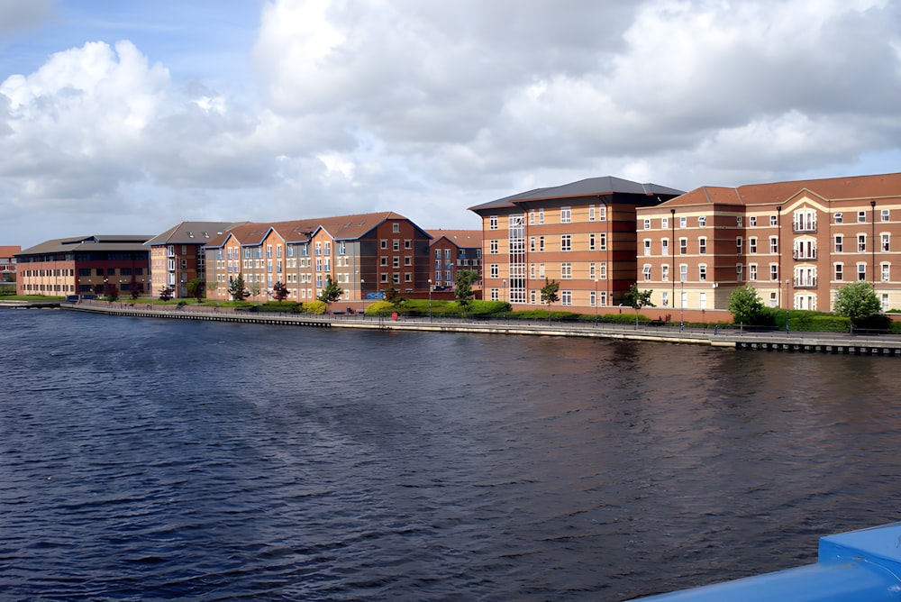 a body of water next to a row of buildings