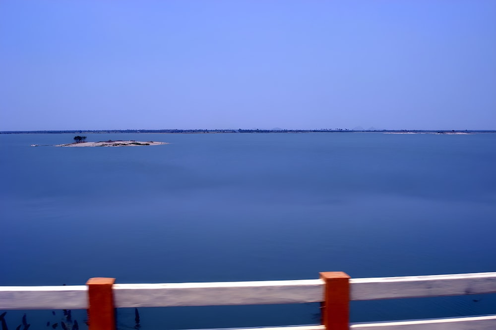 a large body of water with a boat in the distance