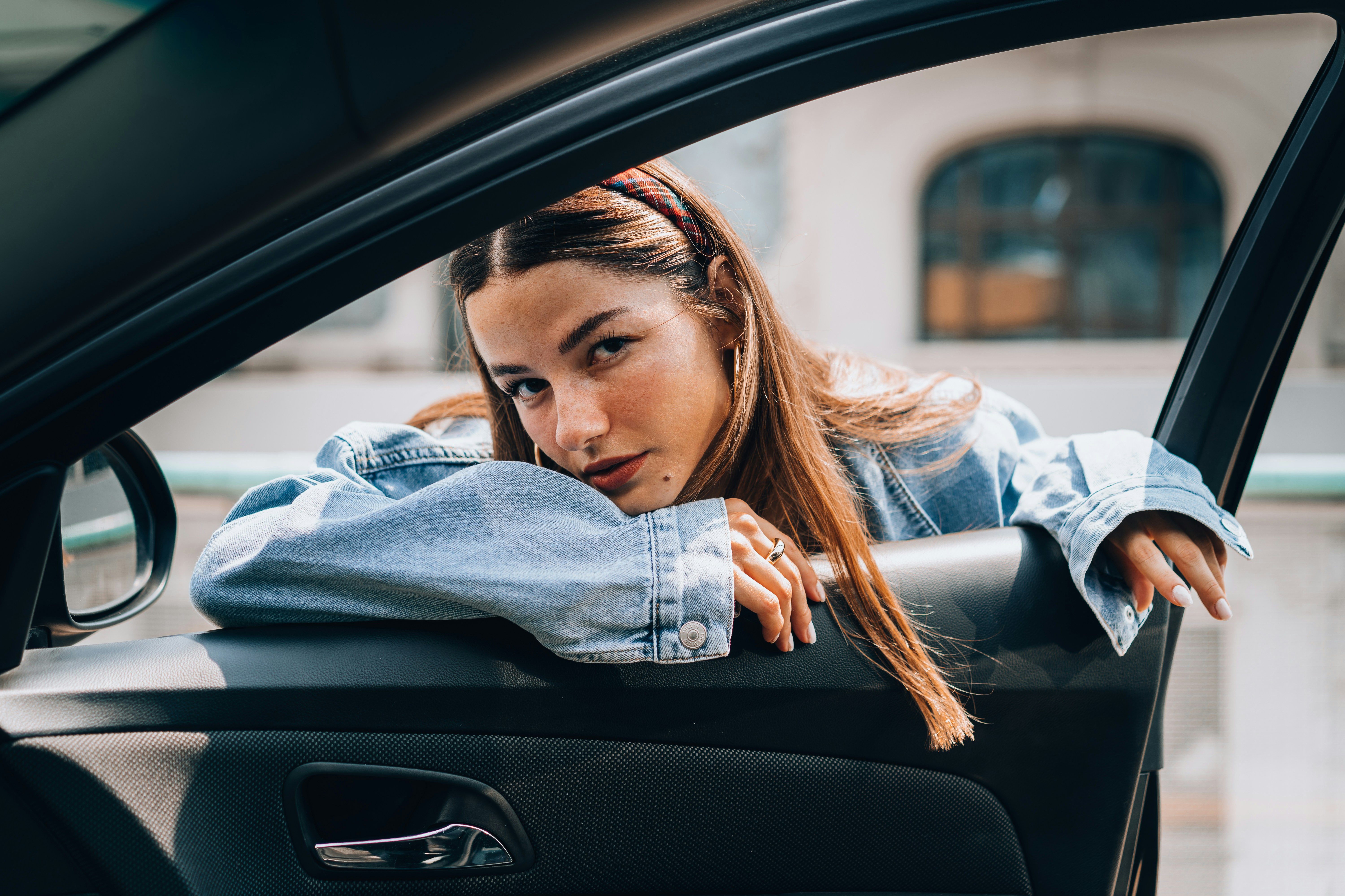 a woman leaning her head out of a car window
