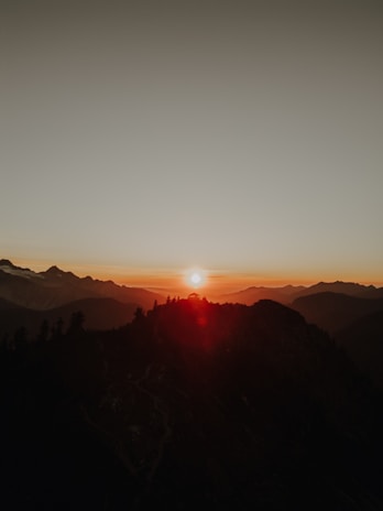 A breathtaking view of a sunset over the mountains.