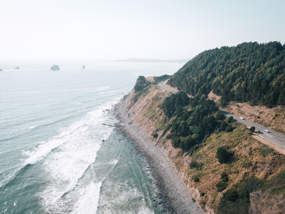 an aerial view of a highway near the ocean