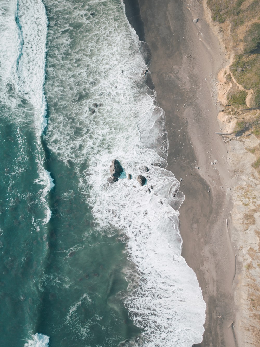 an aerial view of a beach and ocean