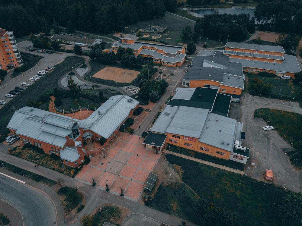 an aerial view of an orange building and parking lot