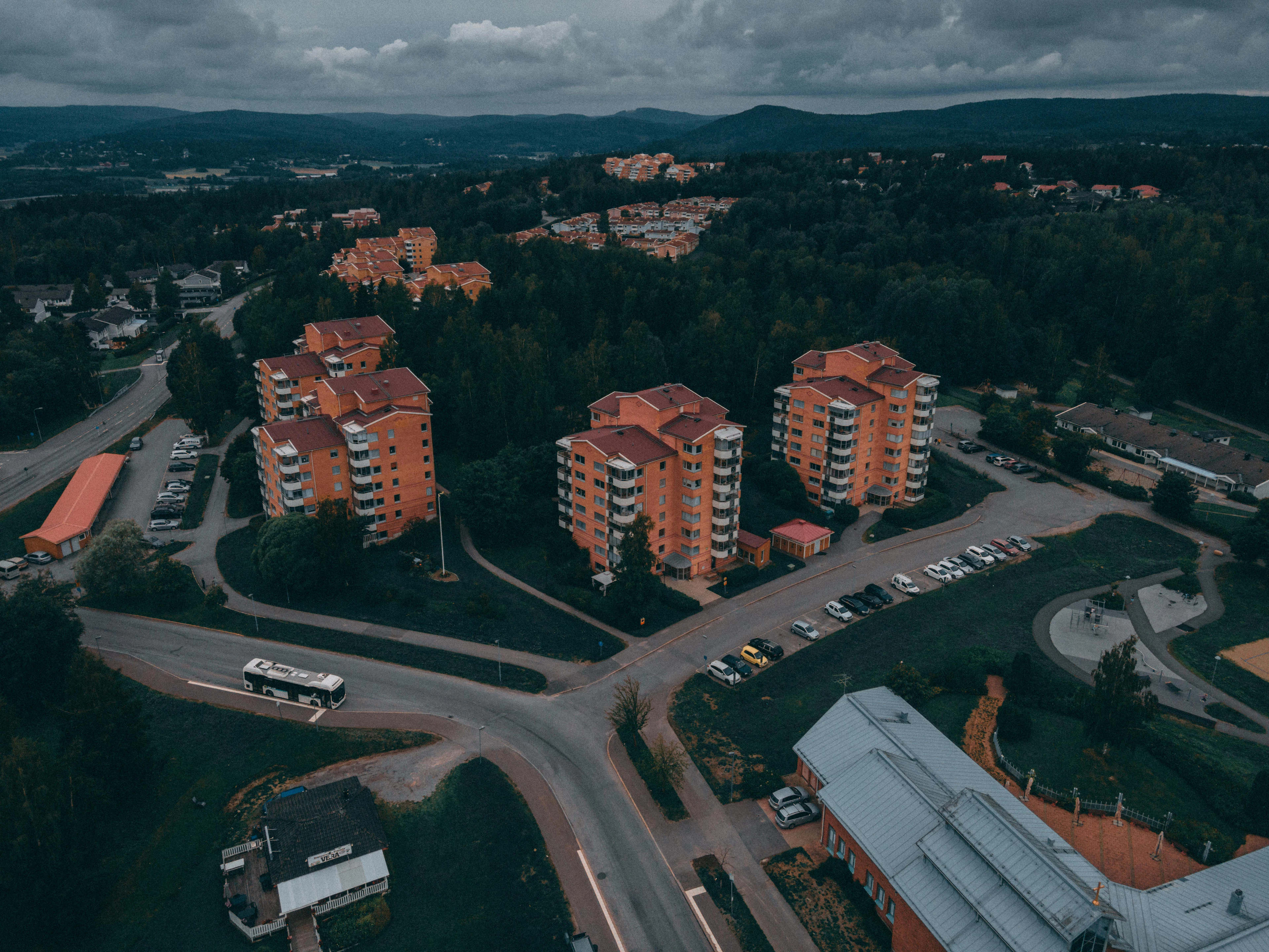 Flygbild över ett bostadsområde med flerfamiljshus en kväll