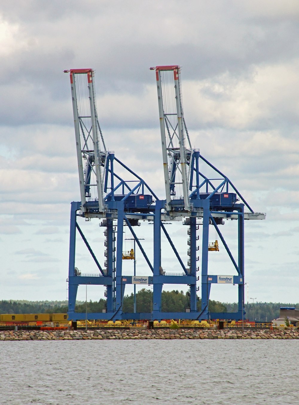 a couple of large cranes sitting on top of a body of water