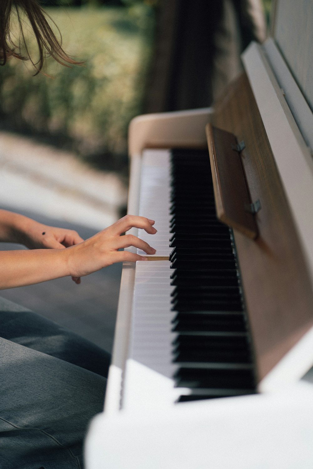 a woman is playing the piano outside