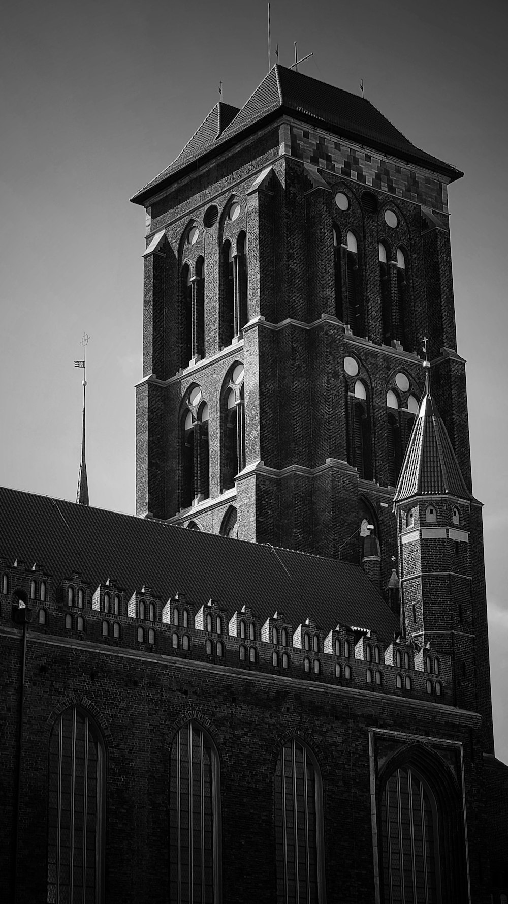 a black and white photo of a church tower