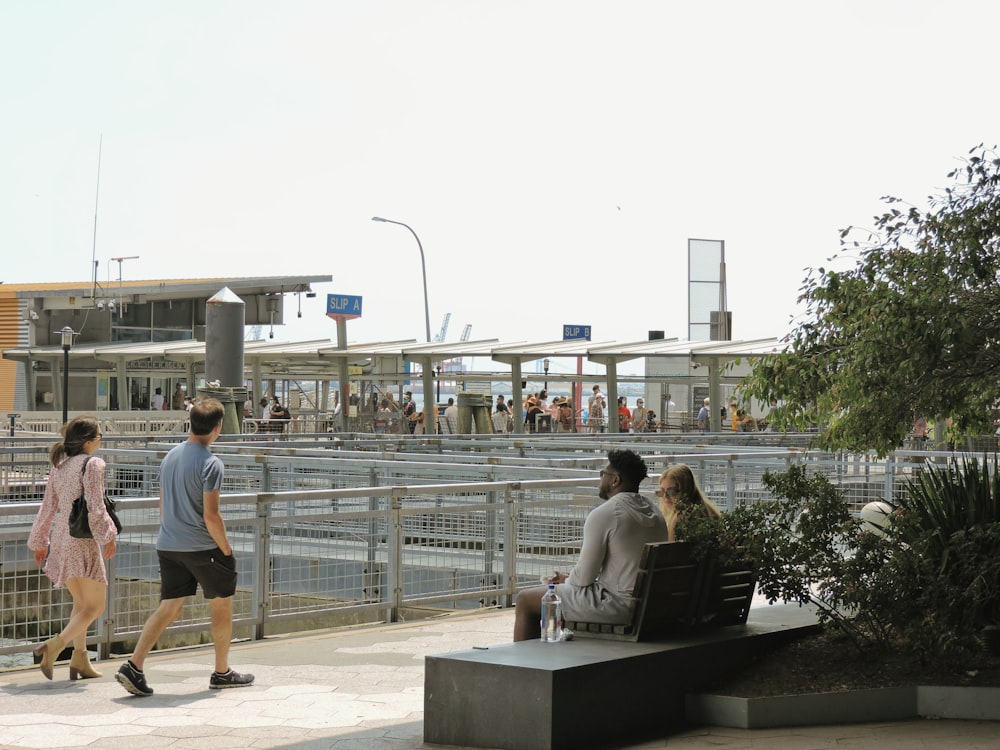 a group of people sitting on top of a bench