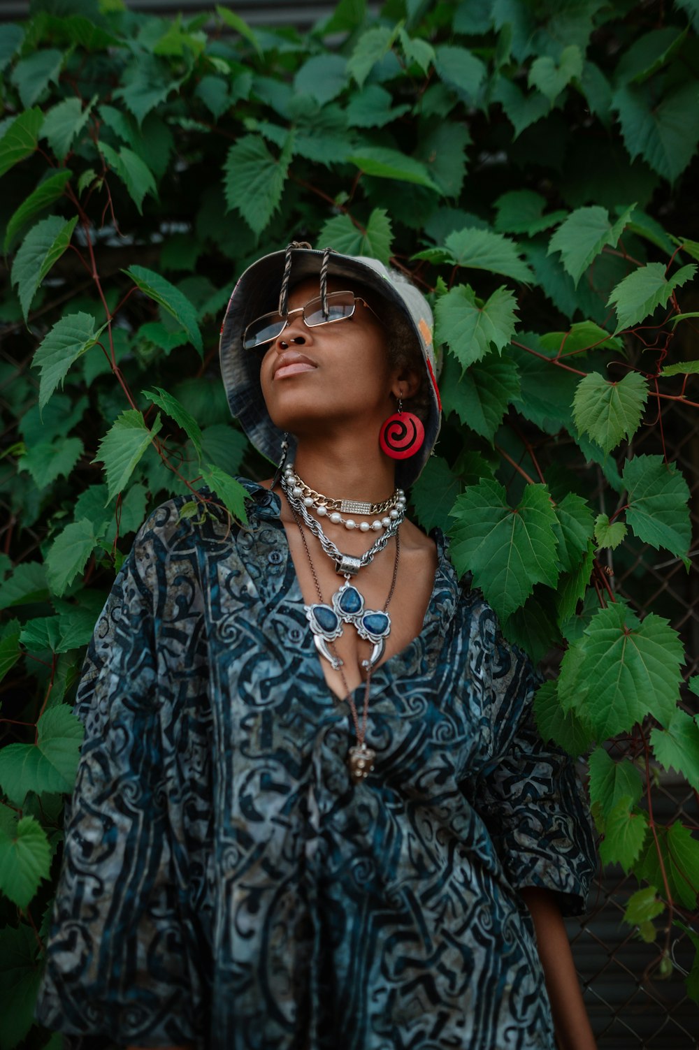 a woman wearing a hat and a necklace