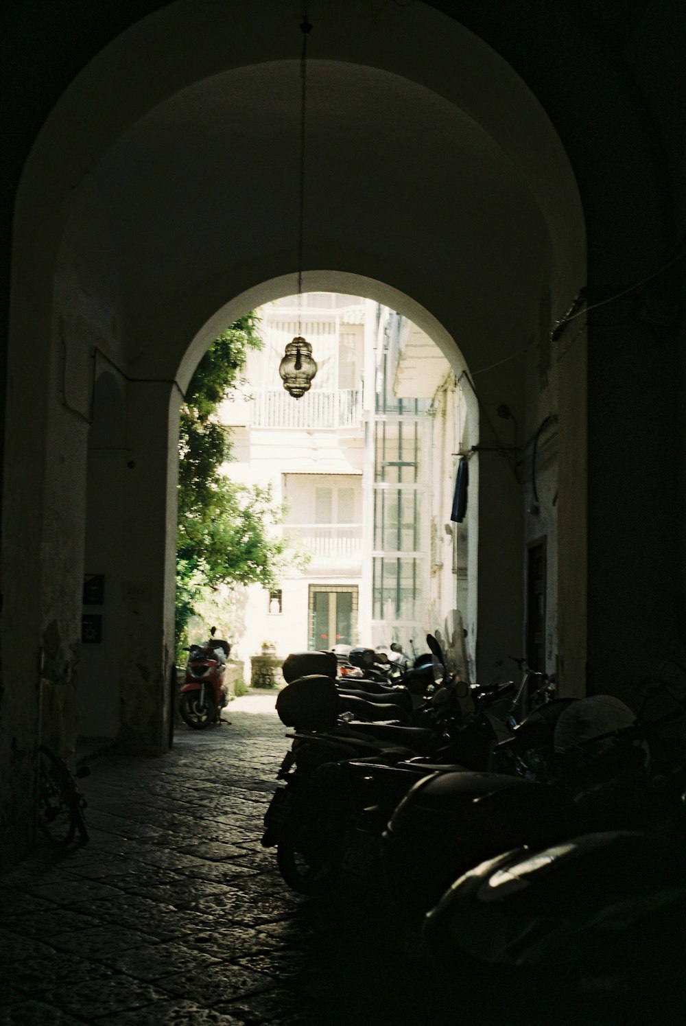 a group of motorcycles are parked in a tunnel