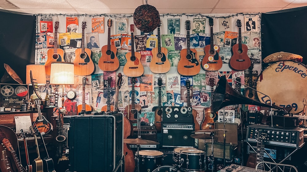 a room filled with lots of guitars and musical equipment
