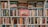 A densely packed bookshelf full of various books, with titles spanning multiple genres and topics. The centerpiece is a prominently displayed red book titled 'Titanic,' featuring an image of the ship. The books are of varying sizes and colors, showcasing a wide array of literary interests.