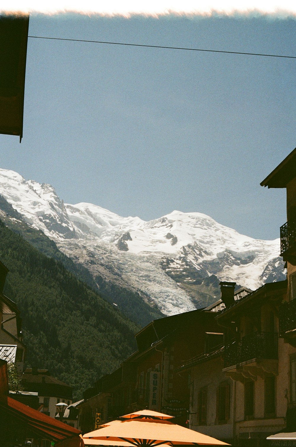 a view of a snow covered mountain from a village