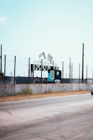 Close-up of a digital billboard mounted on an electric bike displaying a bold message against scam artists in Georgia.