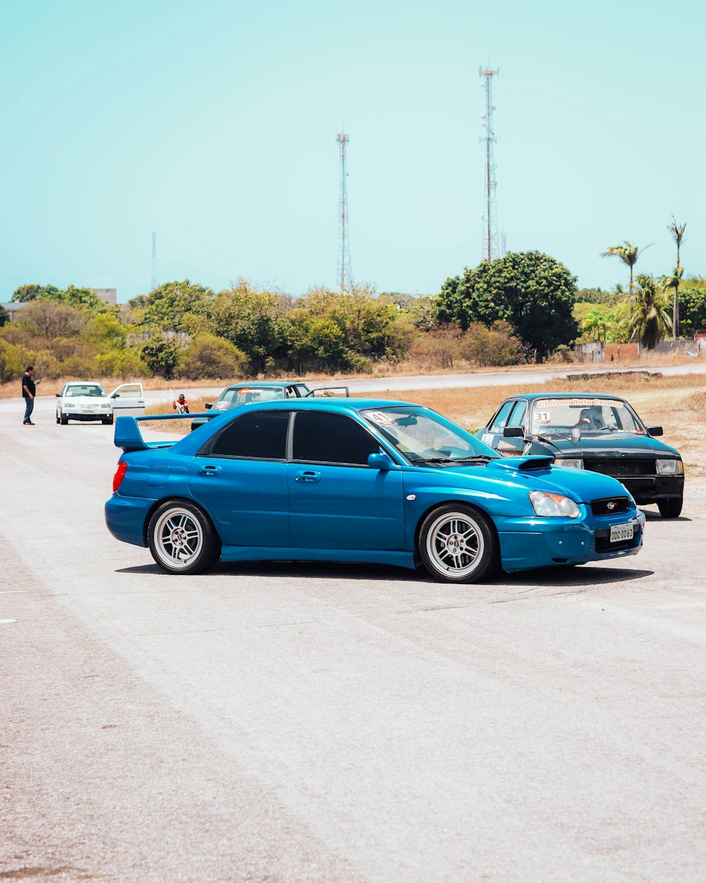 a blue car parked on the side of a road