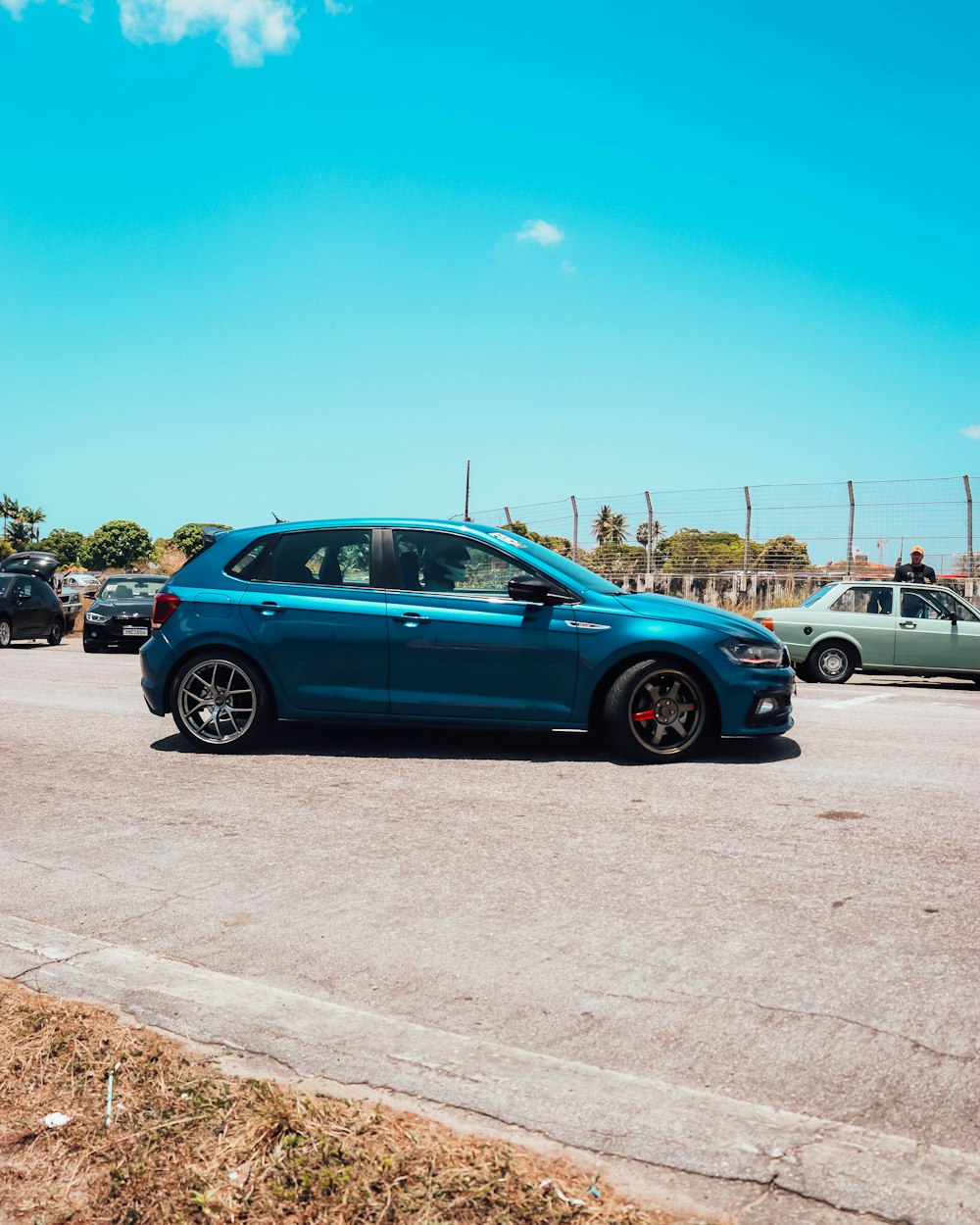 a blue car is parked in a parking lot