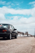 a black car parked on the side of a road