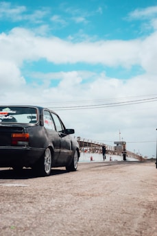 a black car parked on the side of a road