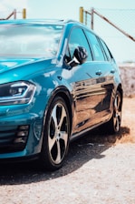 a blue car parked on the side of the road