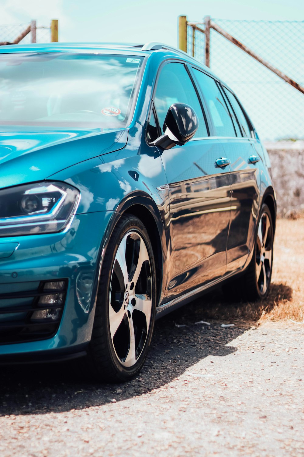 a blue car parked on the side of the road