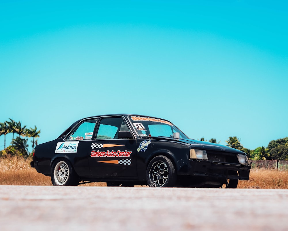 a black car with a racing sticker on it