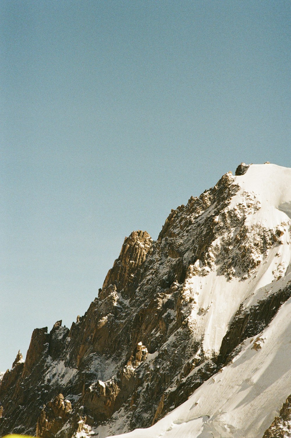 a man riding skis down the side of a snow covered mountain