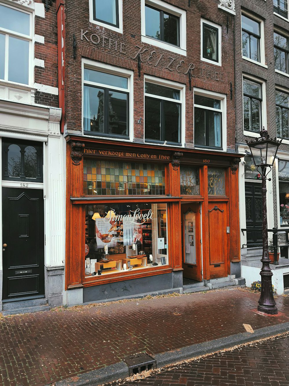 a brick building with a store front on a city street