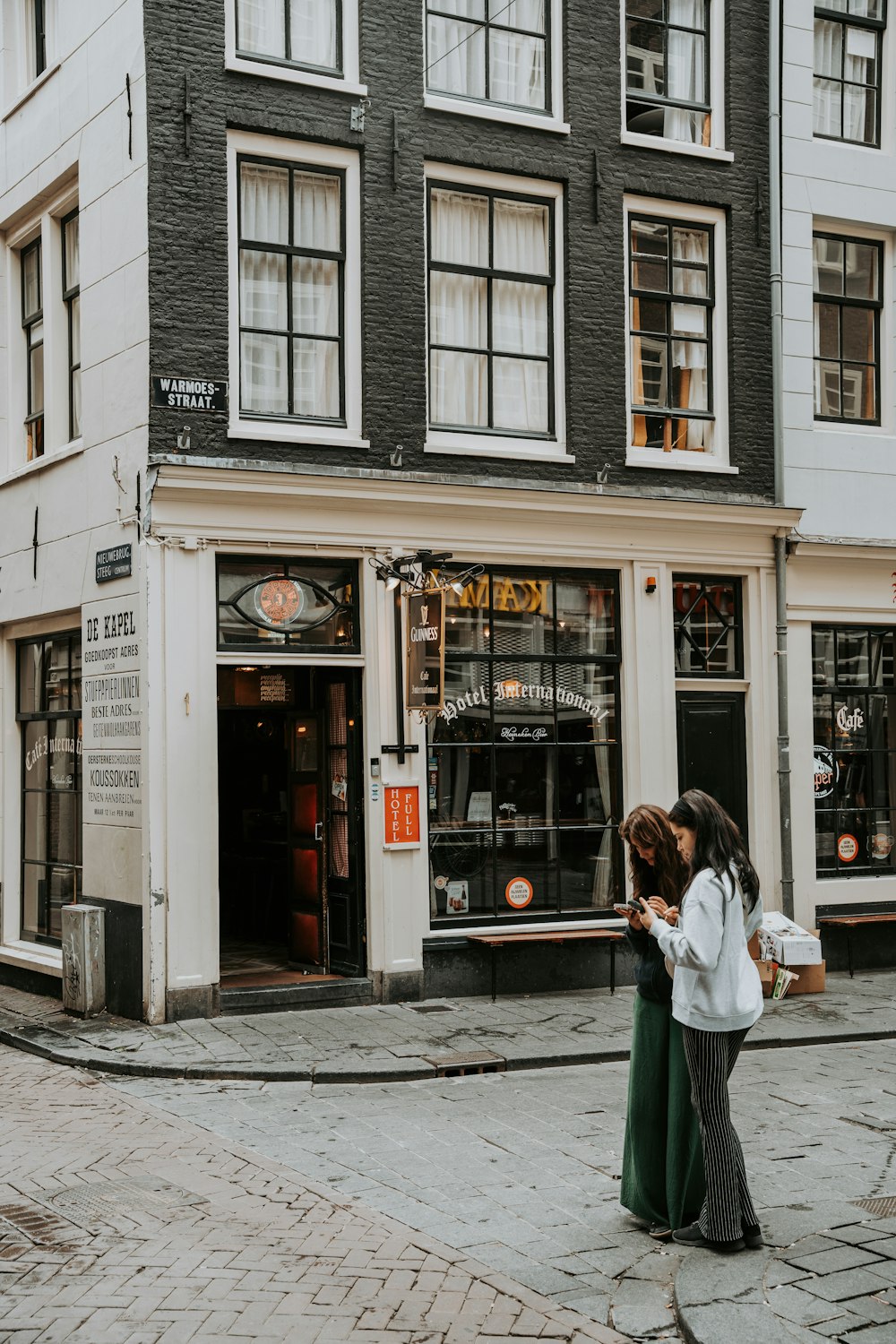 two women standing in front of a store