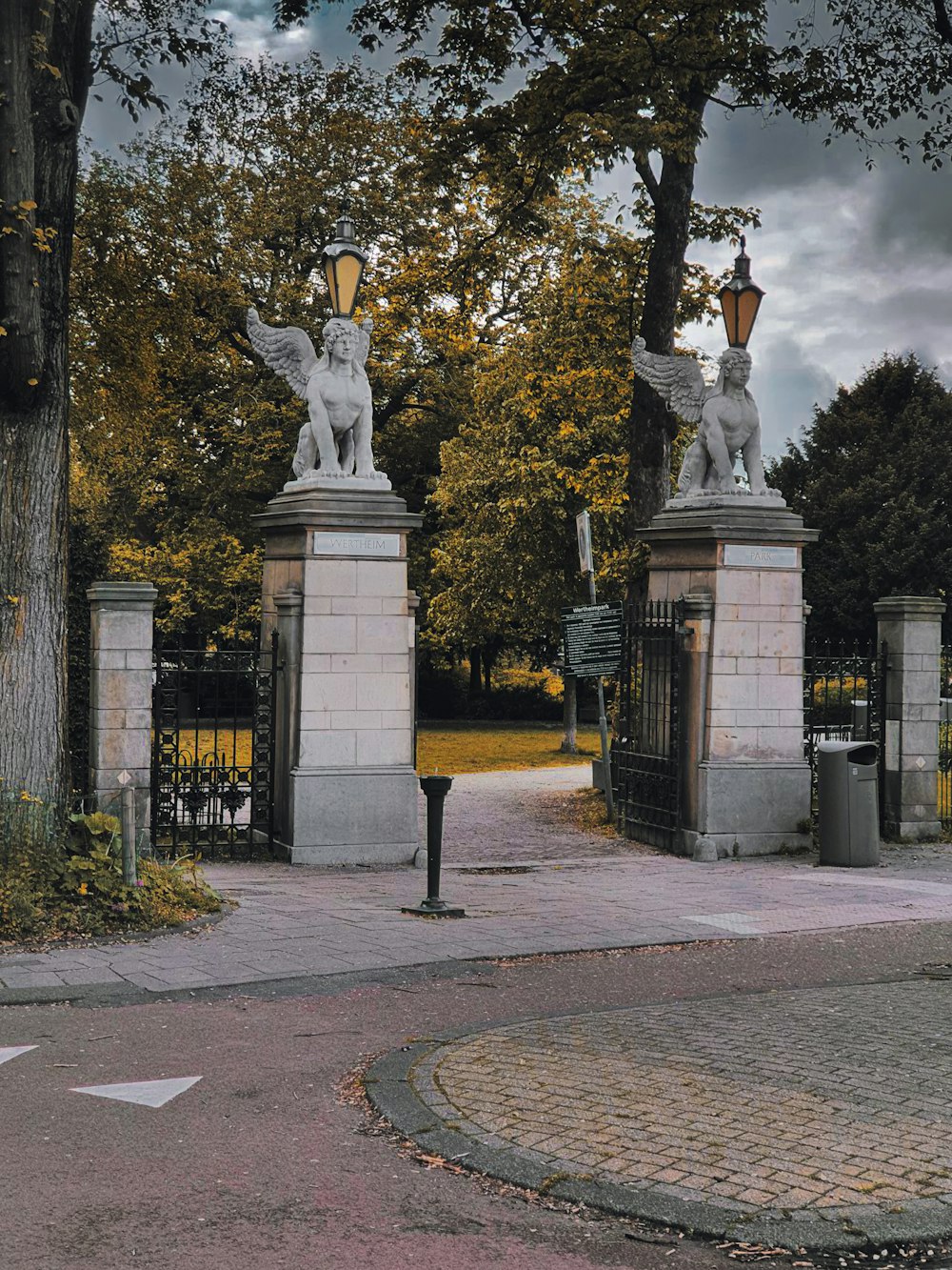 a couple of statues sitting on top of a sidewalk