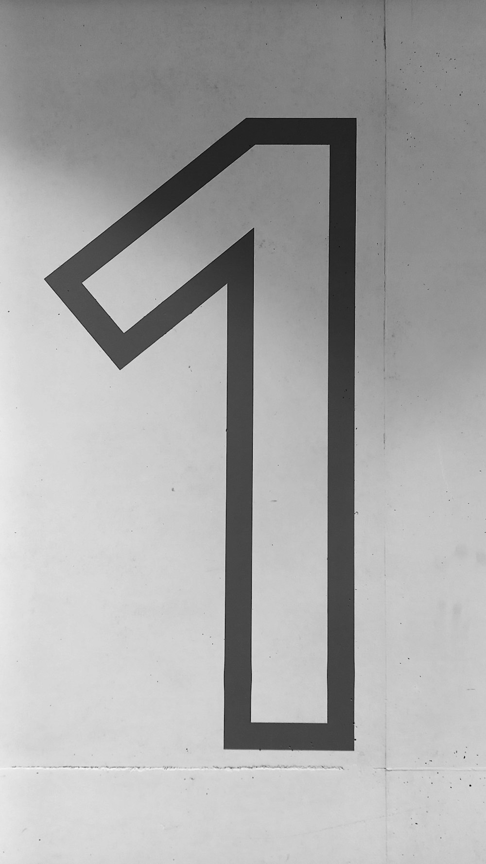a black and white photo of a number one sign