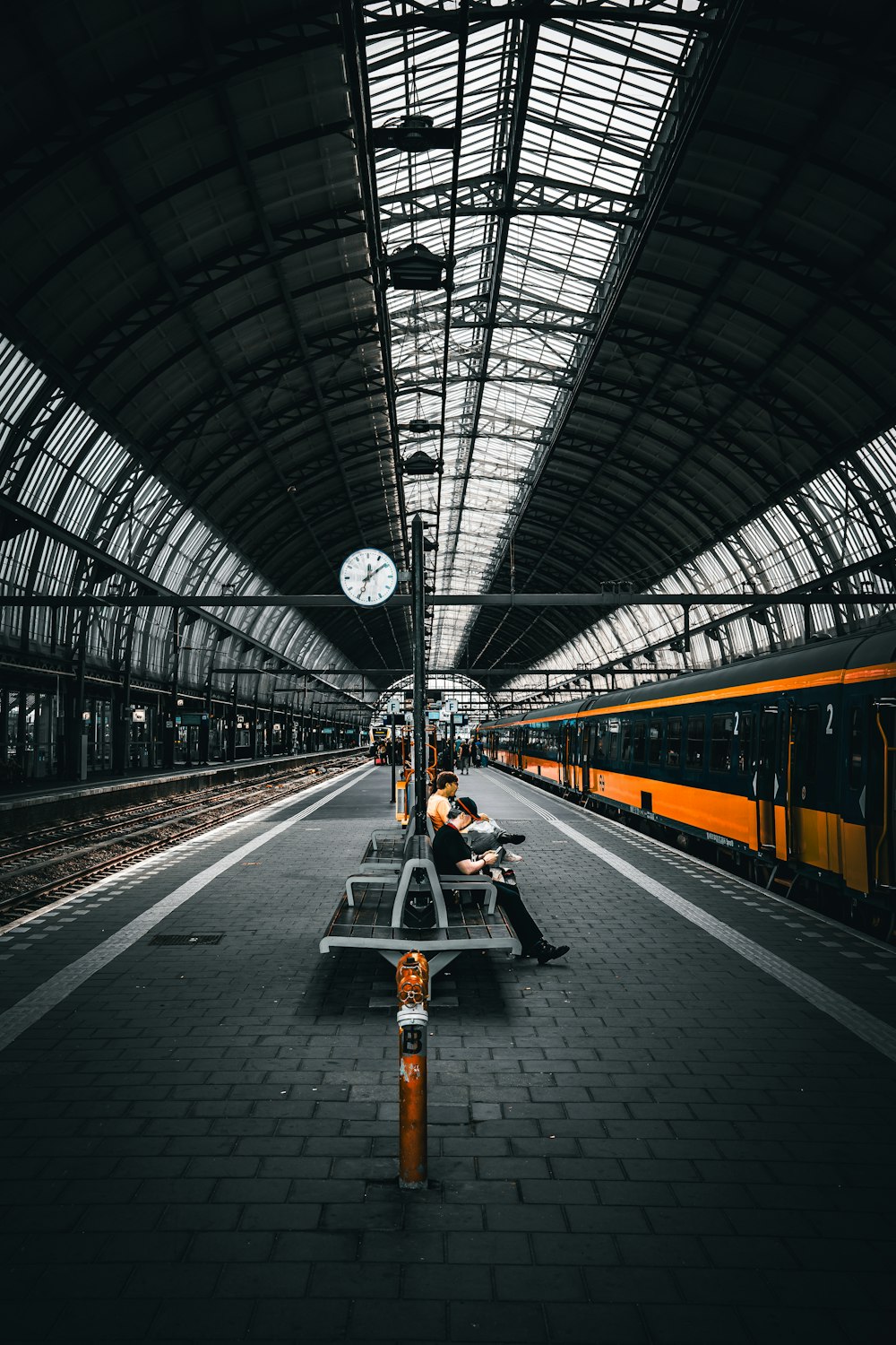 a person sitting on a bench in a train station