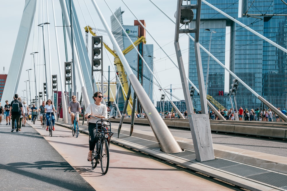 a man riding a bike across a bridge