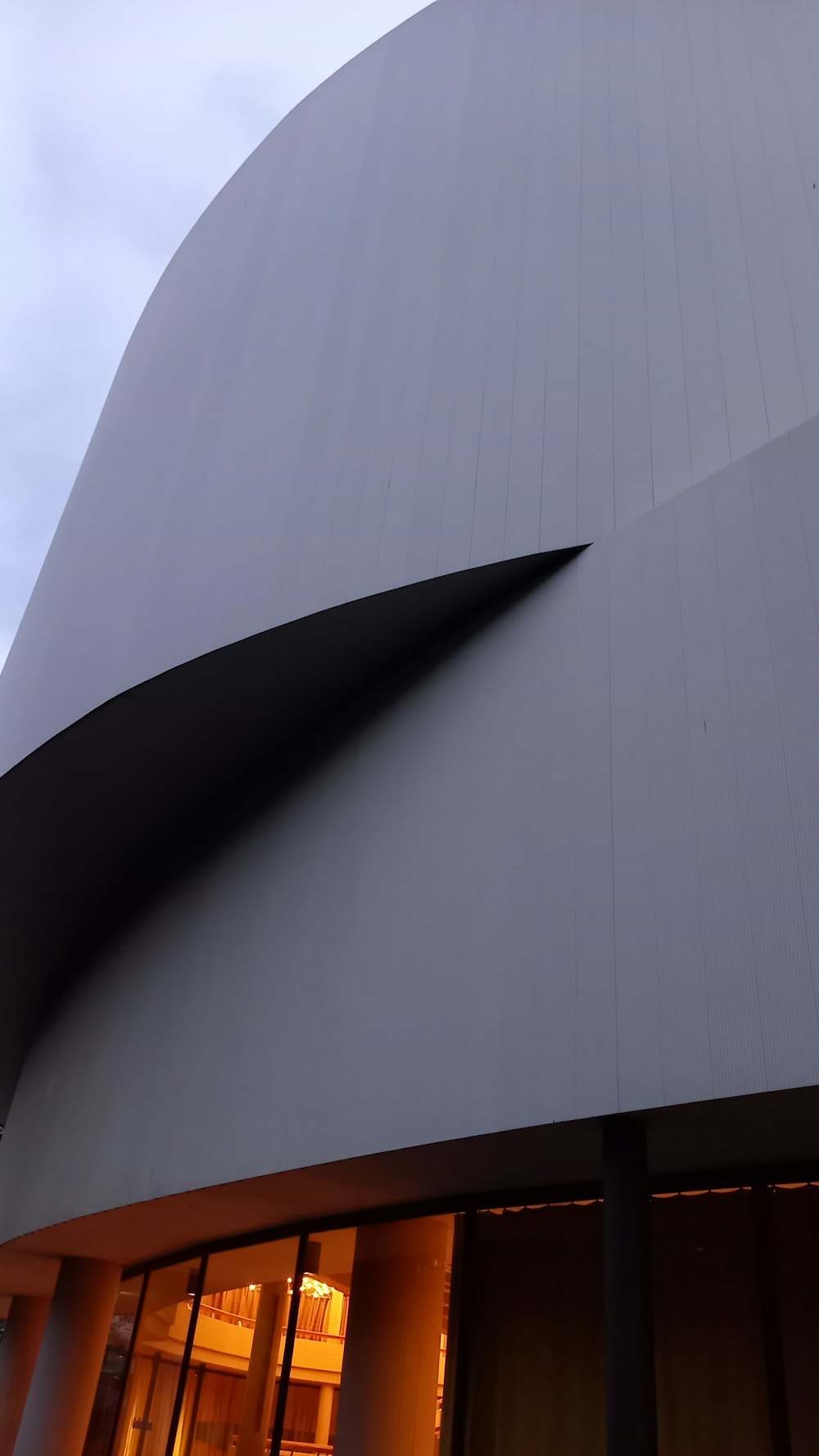 a large building with a curved roof and windows