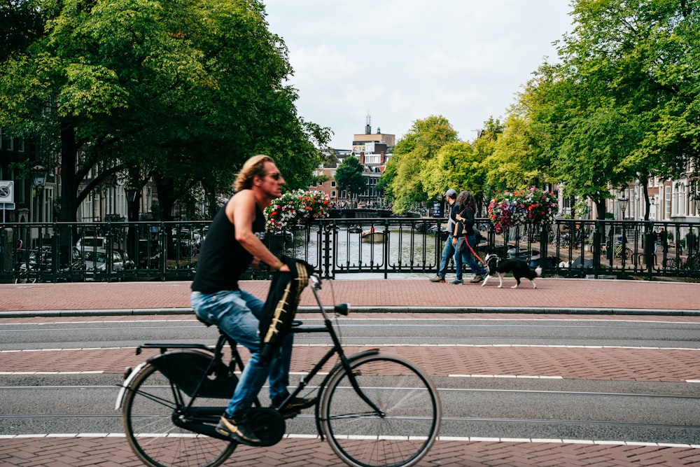 a man riding a bike down a street