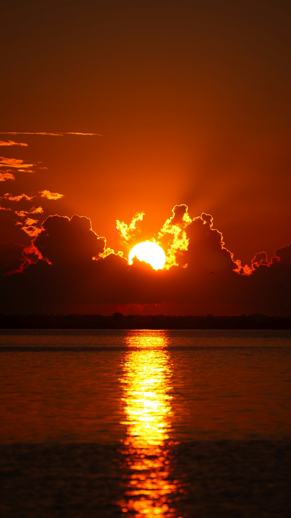 the sun is setting over a body of water