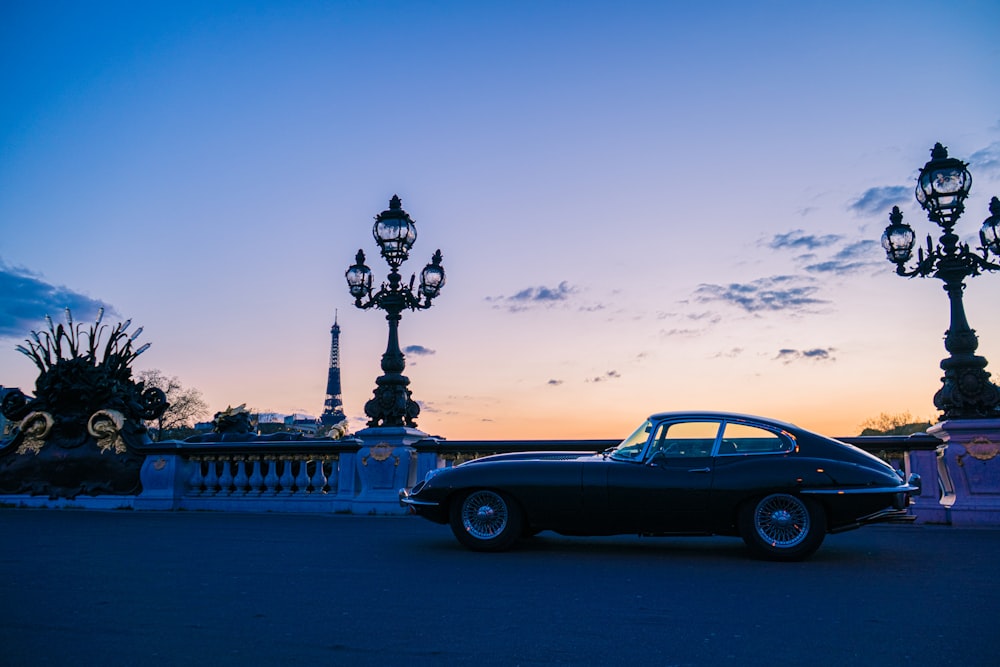 a car parked in front of a street light