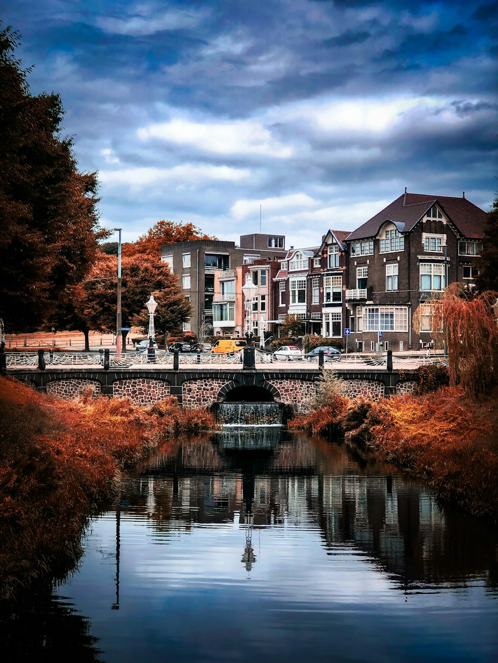 a bridge over a body of water with buildings in the background