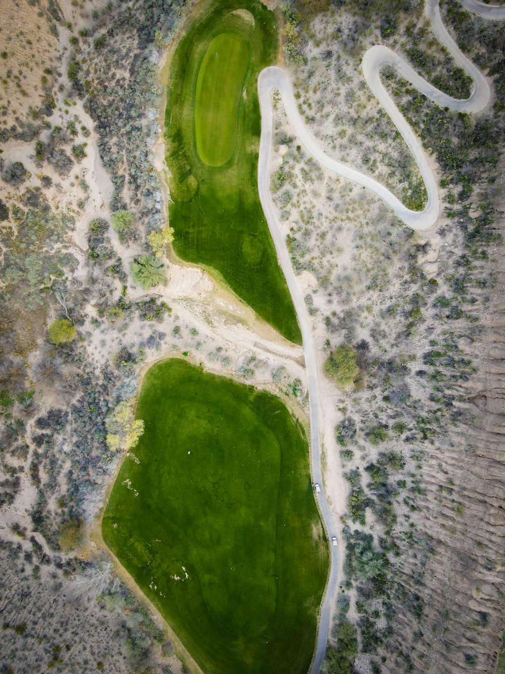 an aerial view of a green golf course