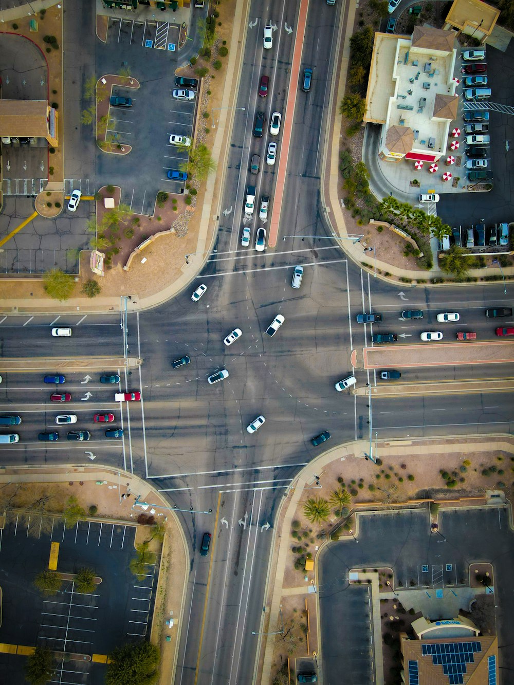 an aerial view of a street intersection with cars