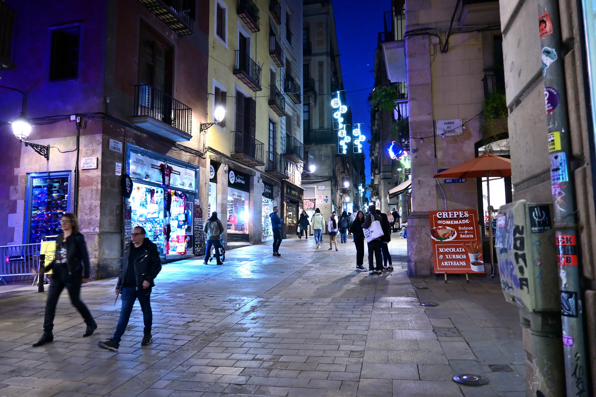 A lively street view of a Ukrainian nightlife scene, with colorful lights and people enjoying the evening.